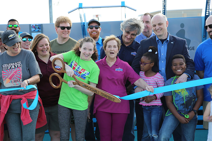 citizens celebrating the ribbon cutting at an outdoor Fitness Court celebration