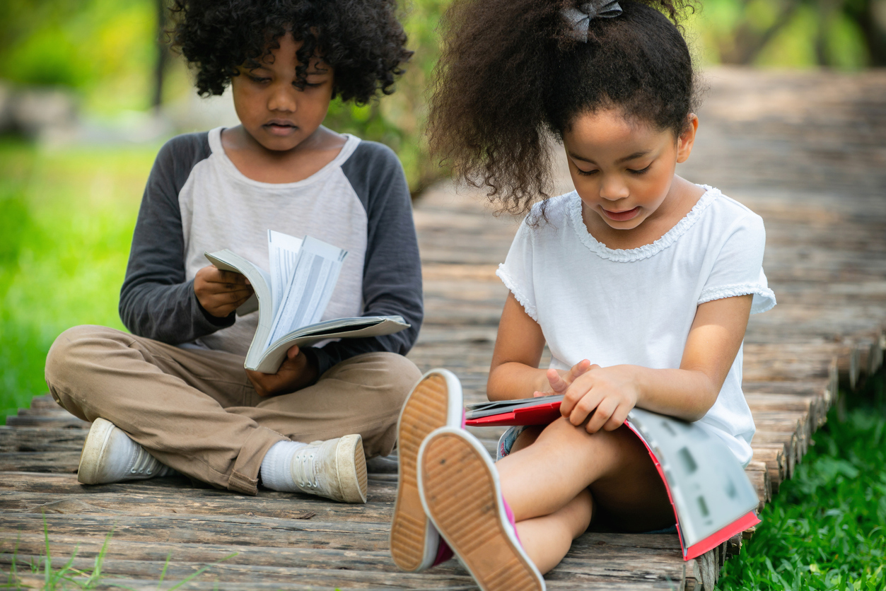 bipoc kids reading outdoors summer