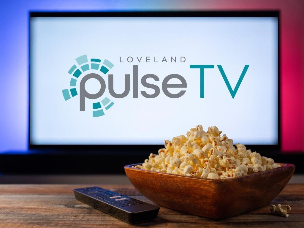 PulseTV logo on TV in front of remote and bowl of popcorn