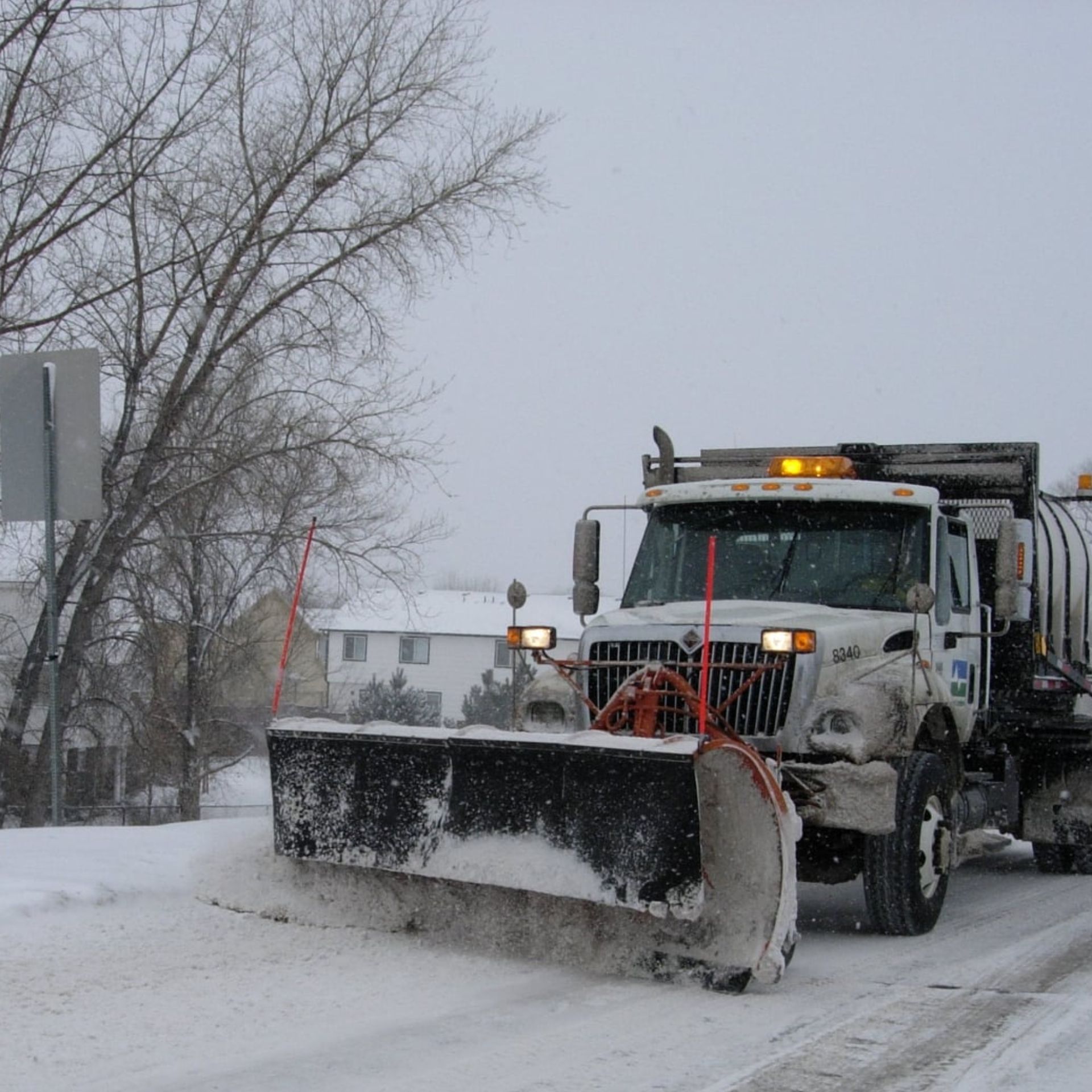 A snowplow in action. Snow is forcefully exiting the moldboard, or 