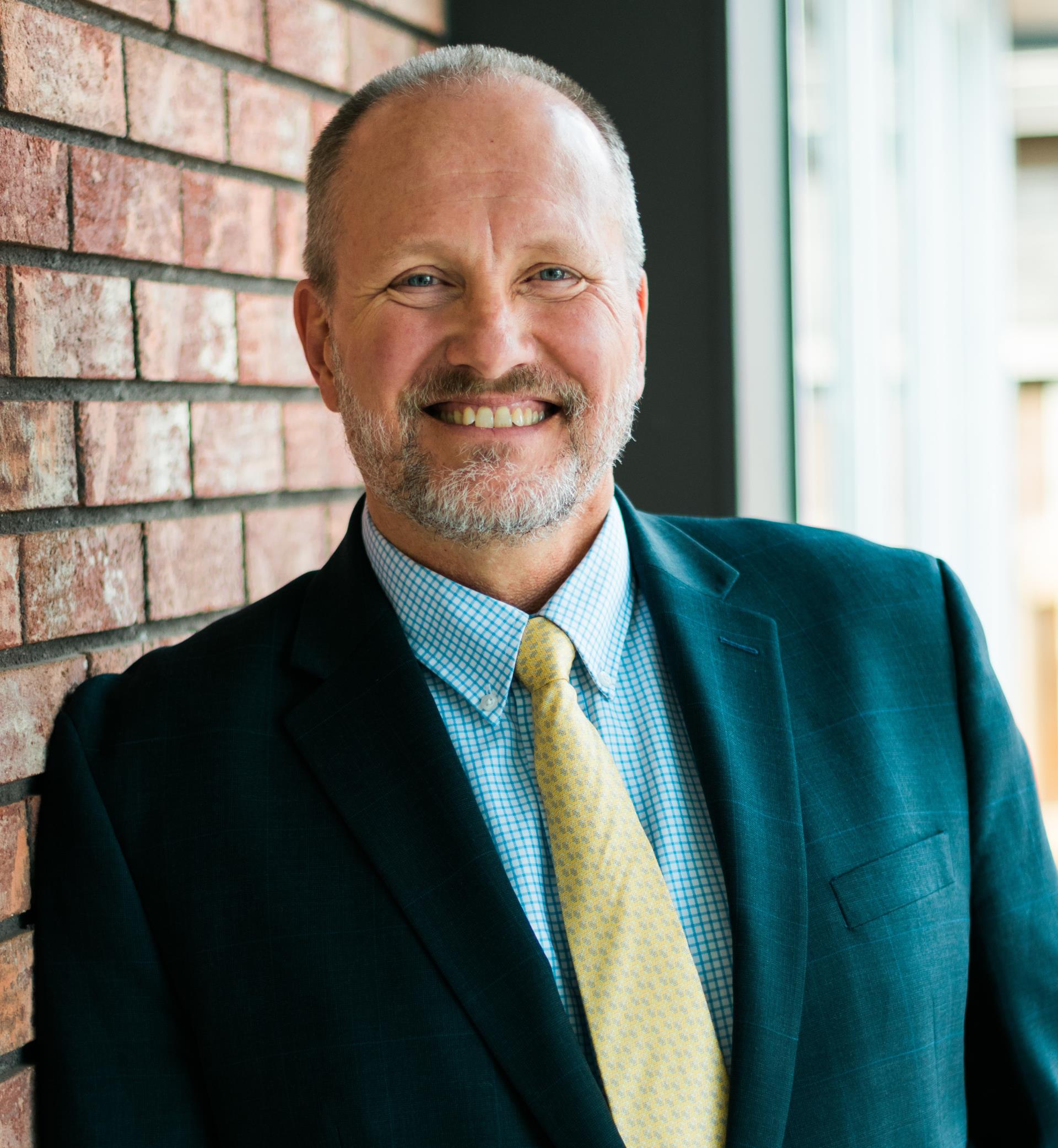 Photo of David Ruppel, the Interim Director for the Northern Colorado Regional Airport in a suit and tie.