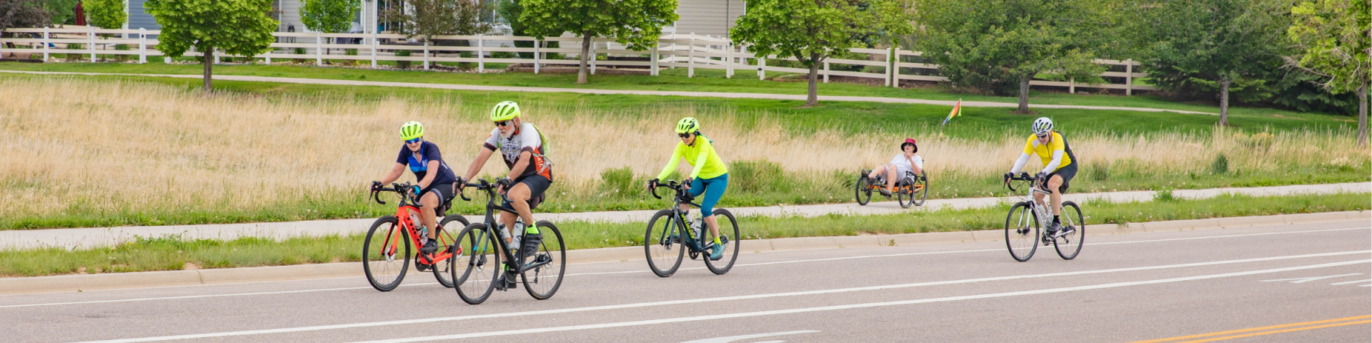 Five people biking on a street.